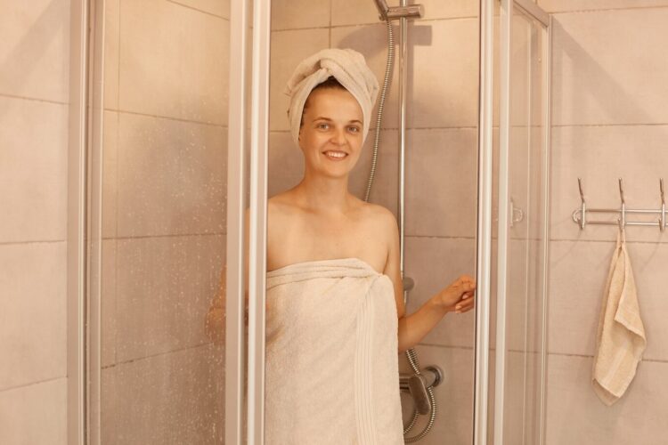 satisfied woman in shower cabine