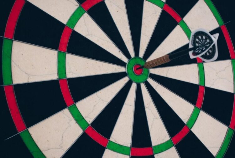 A dart hitting the bullseye of a dart board, symbolizing reaching the target customers with the best customer segmentation software